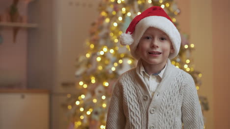 Child-Takes-Off-And-Puts-On-A-Red-Santa-Claus-Hat,-Celebrating-Christmas-At-Home-With-Copy-Space