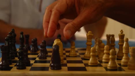 close-up of hands playing chess