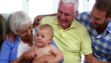 happy family smiling and looking the baby