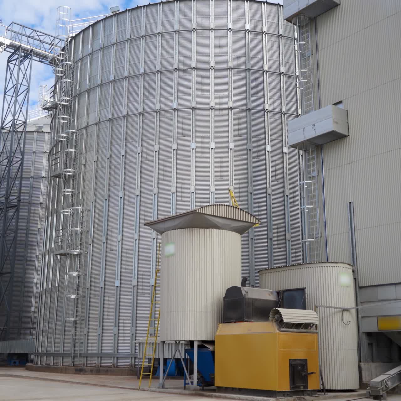 Exterior of modern industry. Large grain elevators for storing and processing agricultural products. Innovative hangar premises of a factory