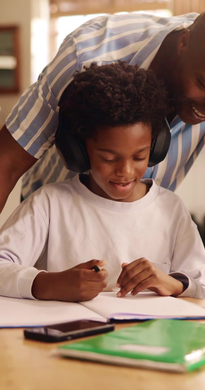 Father Helping Son with Homework at Home