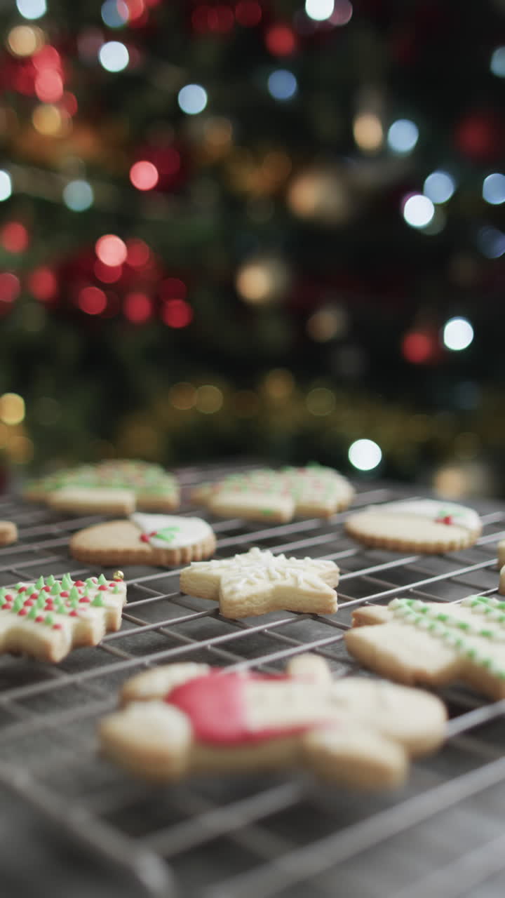 Vertical video of christmas cookies with sugar, chrismtas tree and copy space on black background