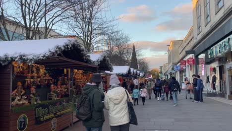 festive christmas market in southampton with wooden stalls, holiday decorations, and people enjoying the seasonal atmosphere.