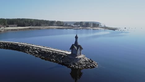 Rocky-shore-with-a-small-Orthodox-chapel-aerial-view