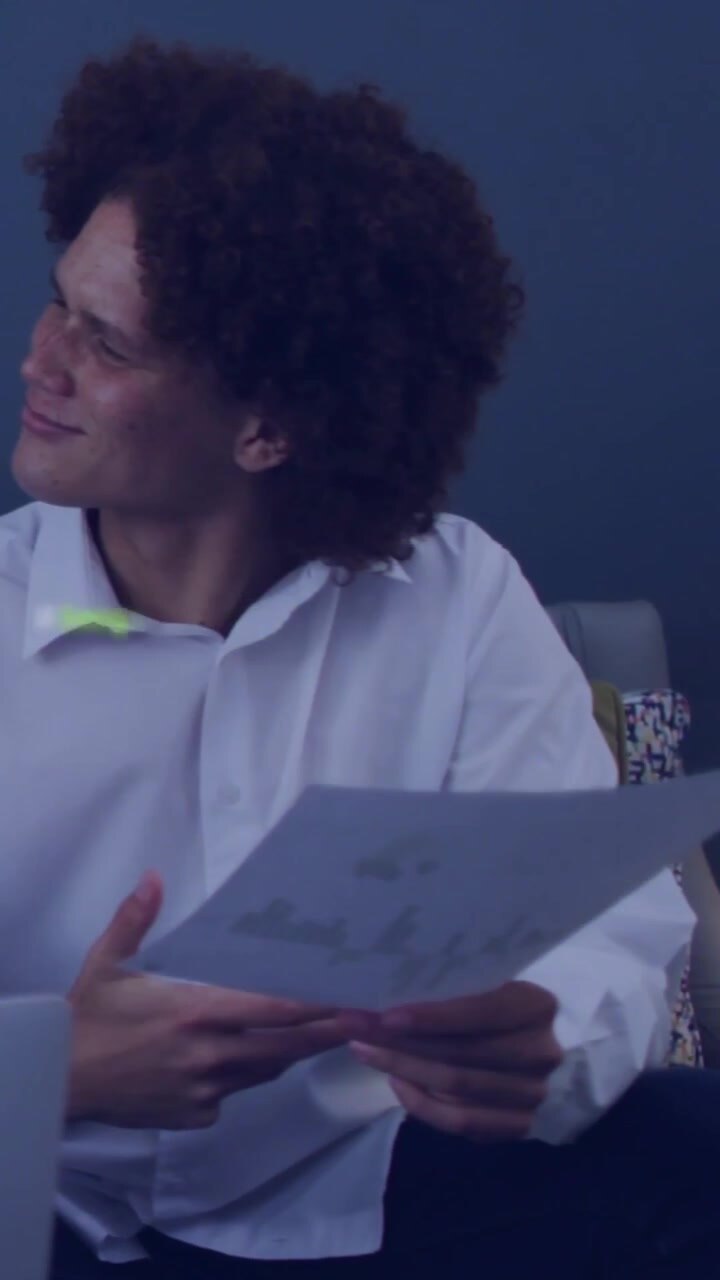 Vertical video: Man studying papers as laptop ping starting green code overlay over person in tech