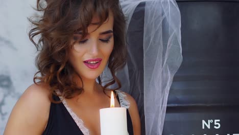 beautiful woman in luxury lingerie. fashion shoot of beautiful woman in luxury lingerie with candle