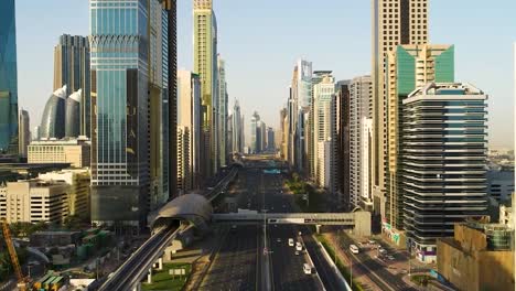 cinematic drone shot of metropolitan city with tall buildings and skyscrapers moving traffic