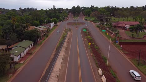 Drone-shot-Argentina-Santa-Ana-Village-Streets-forest-Cars-driving-with-midday-afternoon-with-blue-Sky-cloudy-Landscape-around-Santa-Ana-House-in-the-Forest