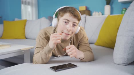 young man having a good time listening to music. happy young man.