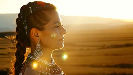 beautiful woman in a golden field at sunset