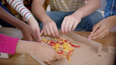 diverse group of teenage friends sitting on couch and sharing pizza at home, slow motion