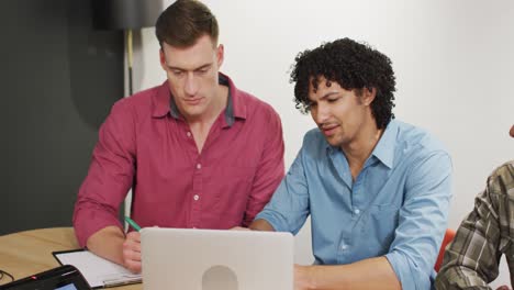 happy diverse business people discussing work during meeting at office