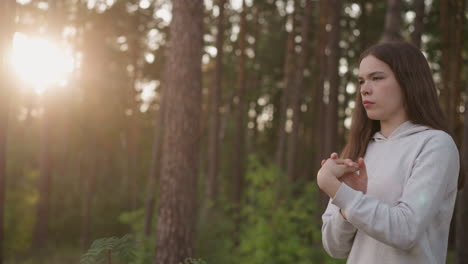 woman in forest at sunset