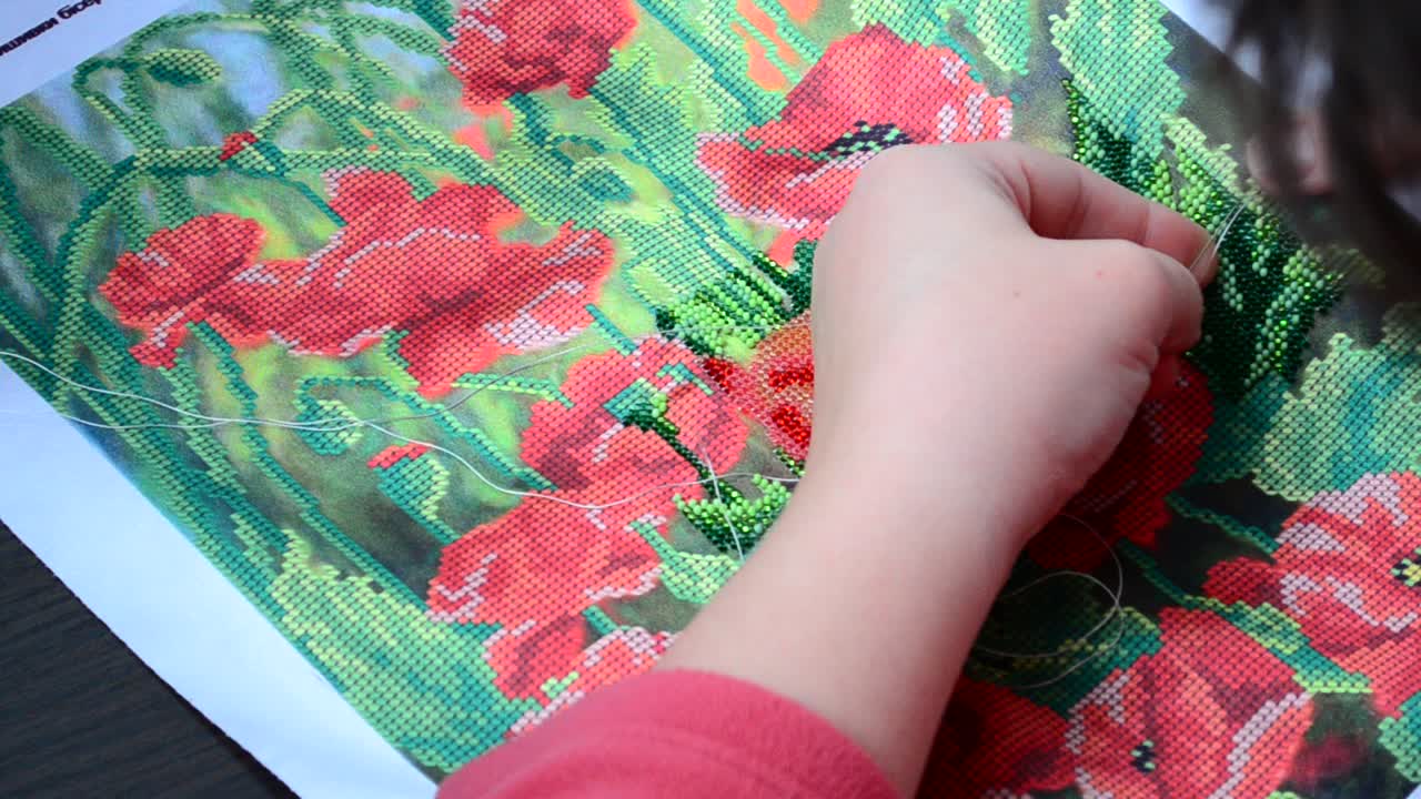 Handwork with beads. Embroidery process