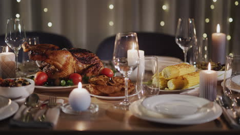 thanksgiving holiday table with turkey in the center of the table