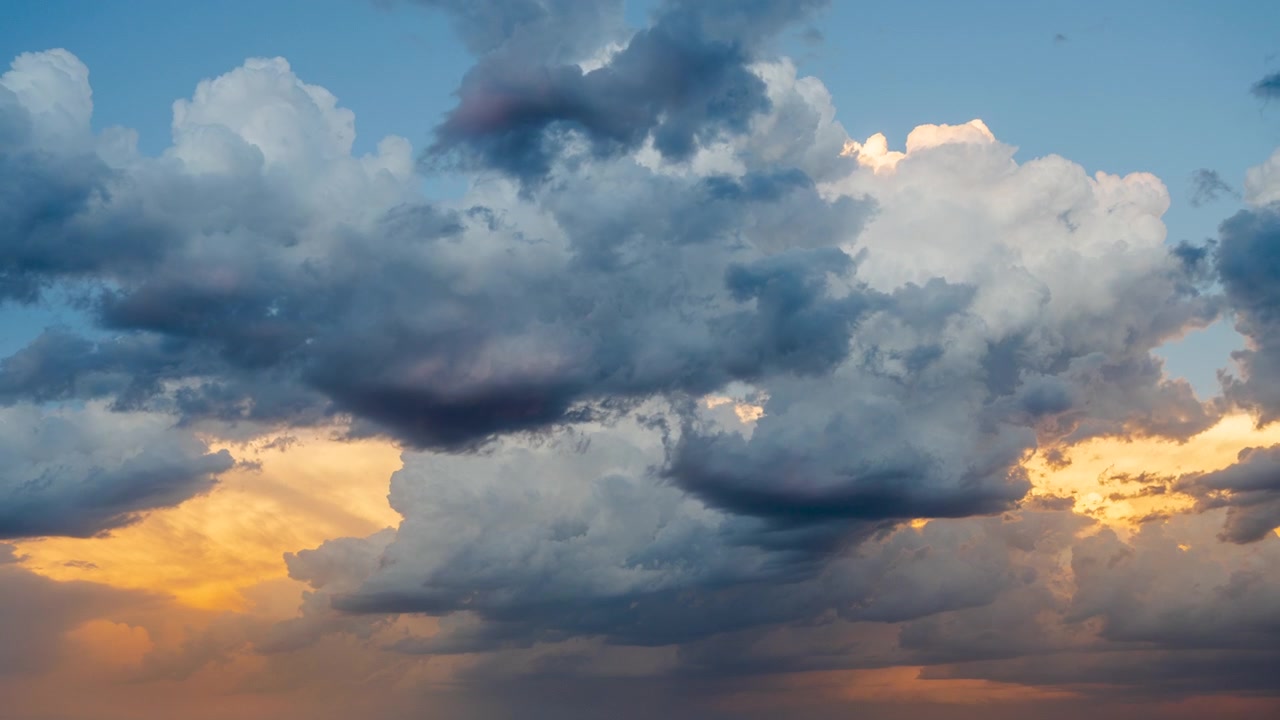 Dramatic orange and pink clouds filling the sky at sunset and dusk