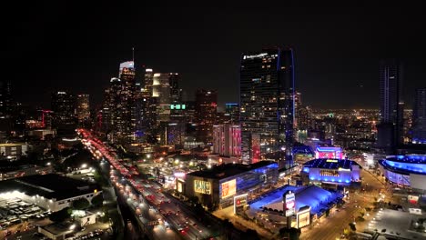 Downtown-Los-Angeles-California-at-nighttime---city-skyline-and-traffic-aerial-establishing-shot