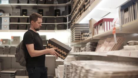 man shopping for storage boxes in a retail store