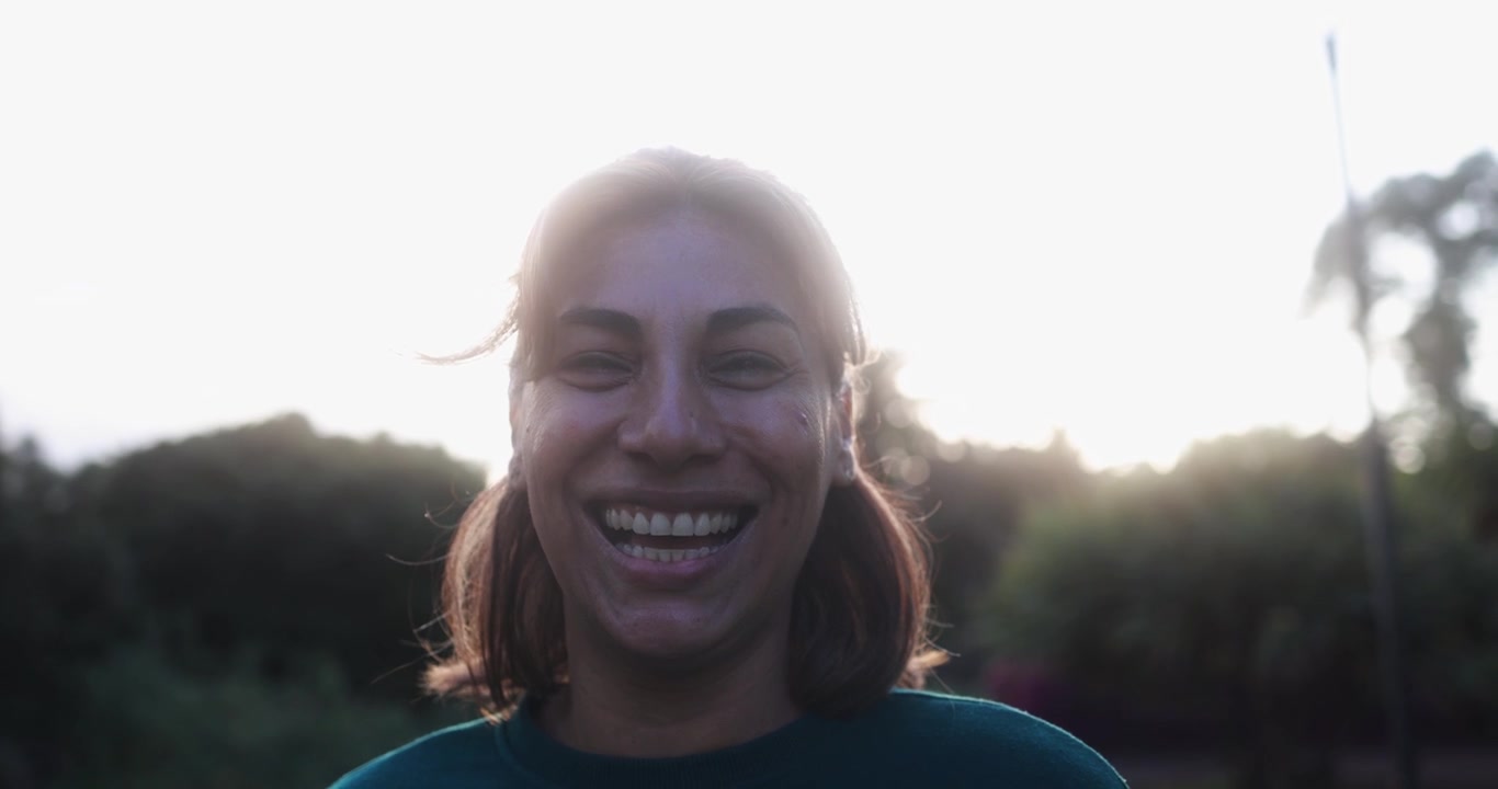 Donna gioiosa che sorride e ride con un bagliore solare
