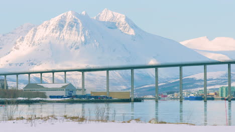 Cinematic-wide-shot-of-Tromso-bridge-with-mountains-behind