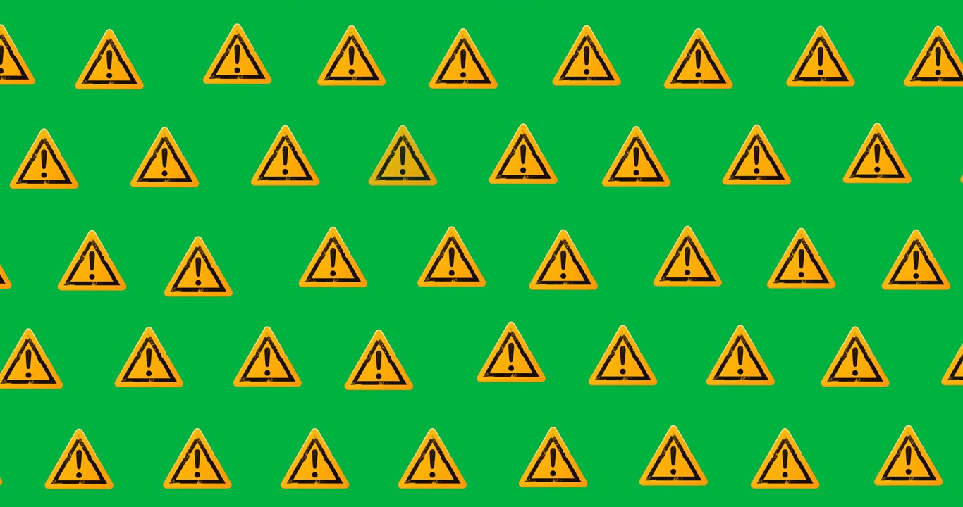 Digital animation of multiple attention sign icons in seamless pattern on black background