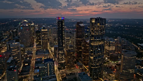 Calgary-AB-Canada-Aerial-v1-dusk-hyperlapse-drone-fly-around-capturing-panoramic-panning-views-of-downtown-cityscape-with-light-up-streets-and-skyscrapers---Shot-with-Mavic-3-Pro-Cine---July-2023