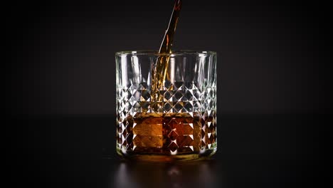 cola being poured into a glass with ice