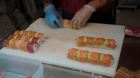 preparing sushi at a sushi bar and take away