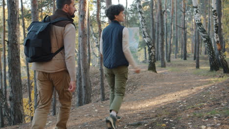 Hikers Exploring Forest Path with Map