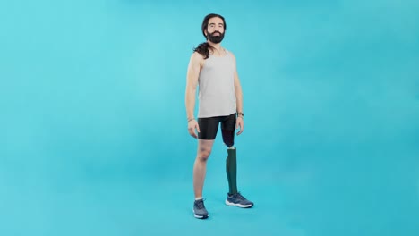man with prosthetic leg standing against blue background
