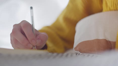 hand of woman writing document, front close up view