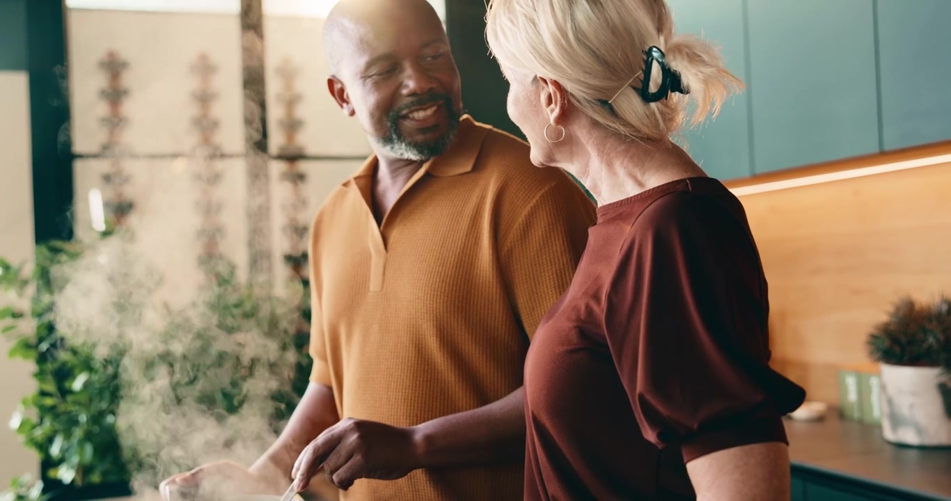 Mature Couple Cooking Together in Modern Kitchen