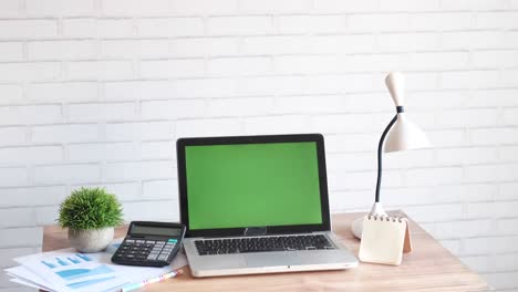 modern workspace with laptop, calculator, and lamp