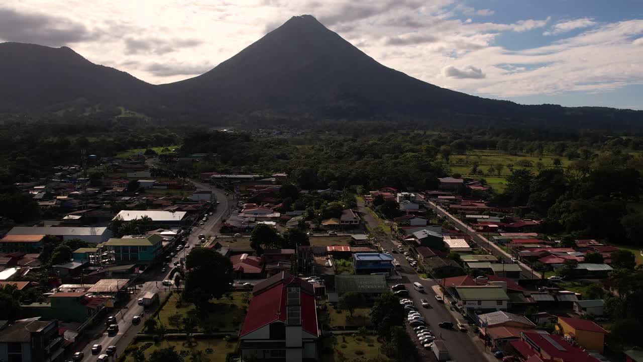 Vila La Fortuna contra a luz com o vulcão Arenal ao fundo