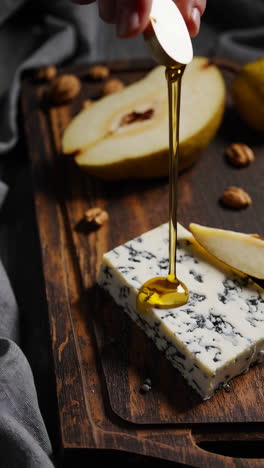 honey drizzled on blue cheese with pear and walnuts