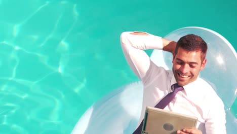 businessman using tablet pc on inflatable