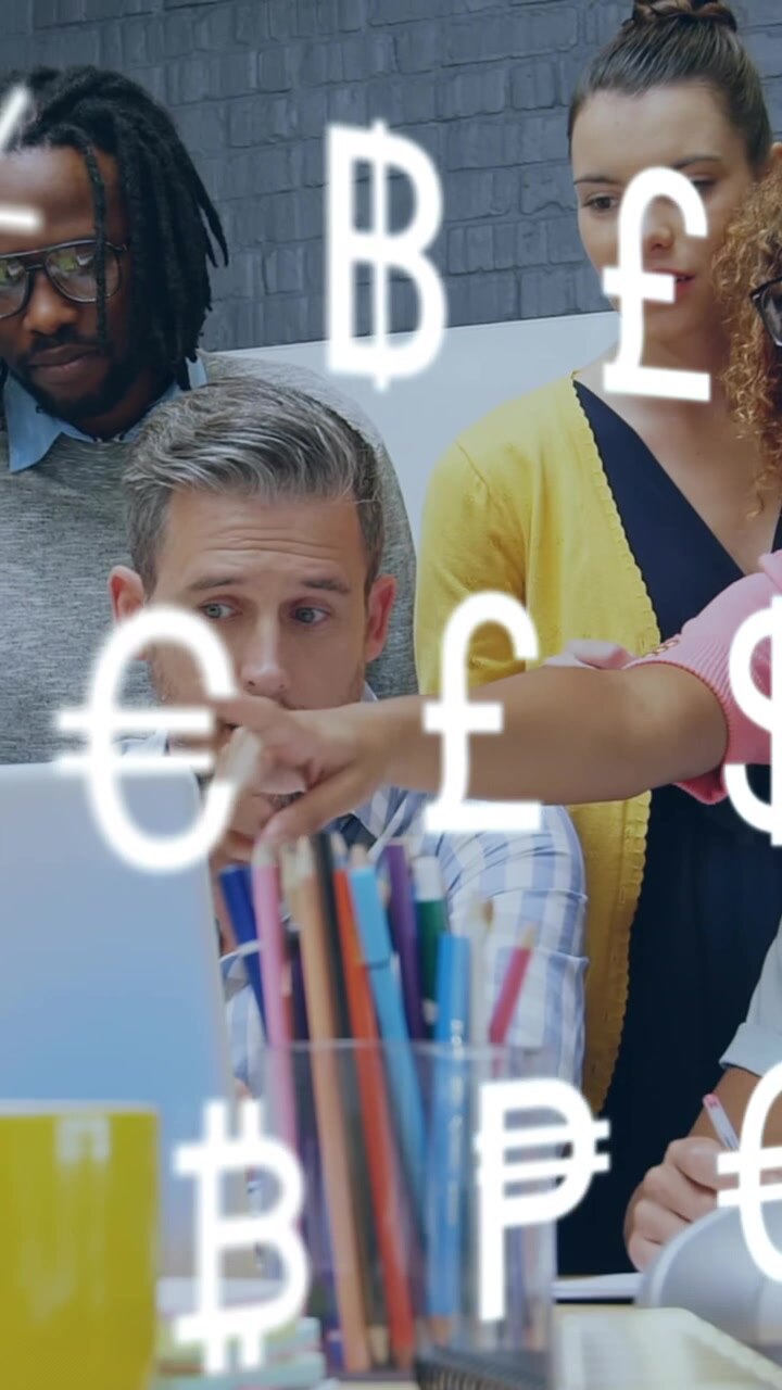 Animation of currency symbols against diverse colleagues discussing together over a laptop at office