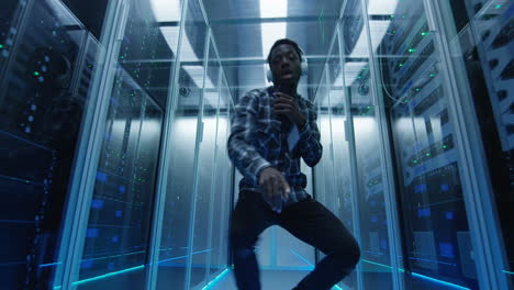 energetic technician dancing in a futuristic server room
