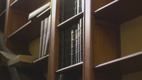 old books on a bookshelf. tilt shot