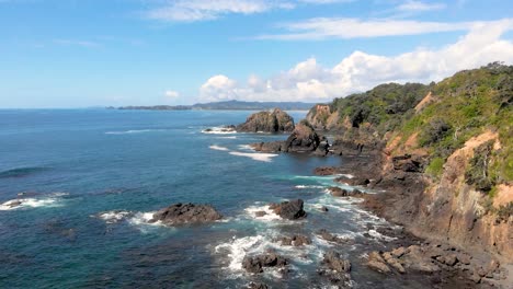 aerial drone flying over a beautiful rocky shore with crashing waves