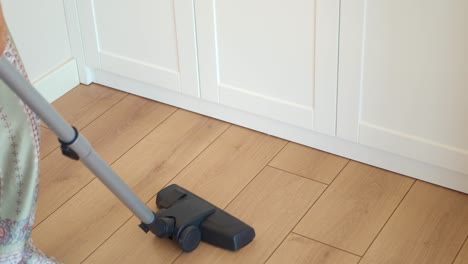 cleaning a kitchen with a vacuum cleaner