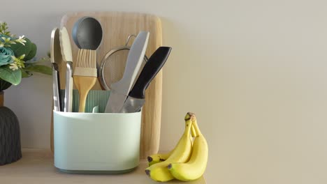 kitchen utensils and bananas on countertop