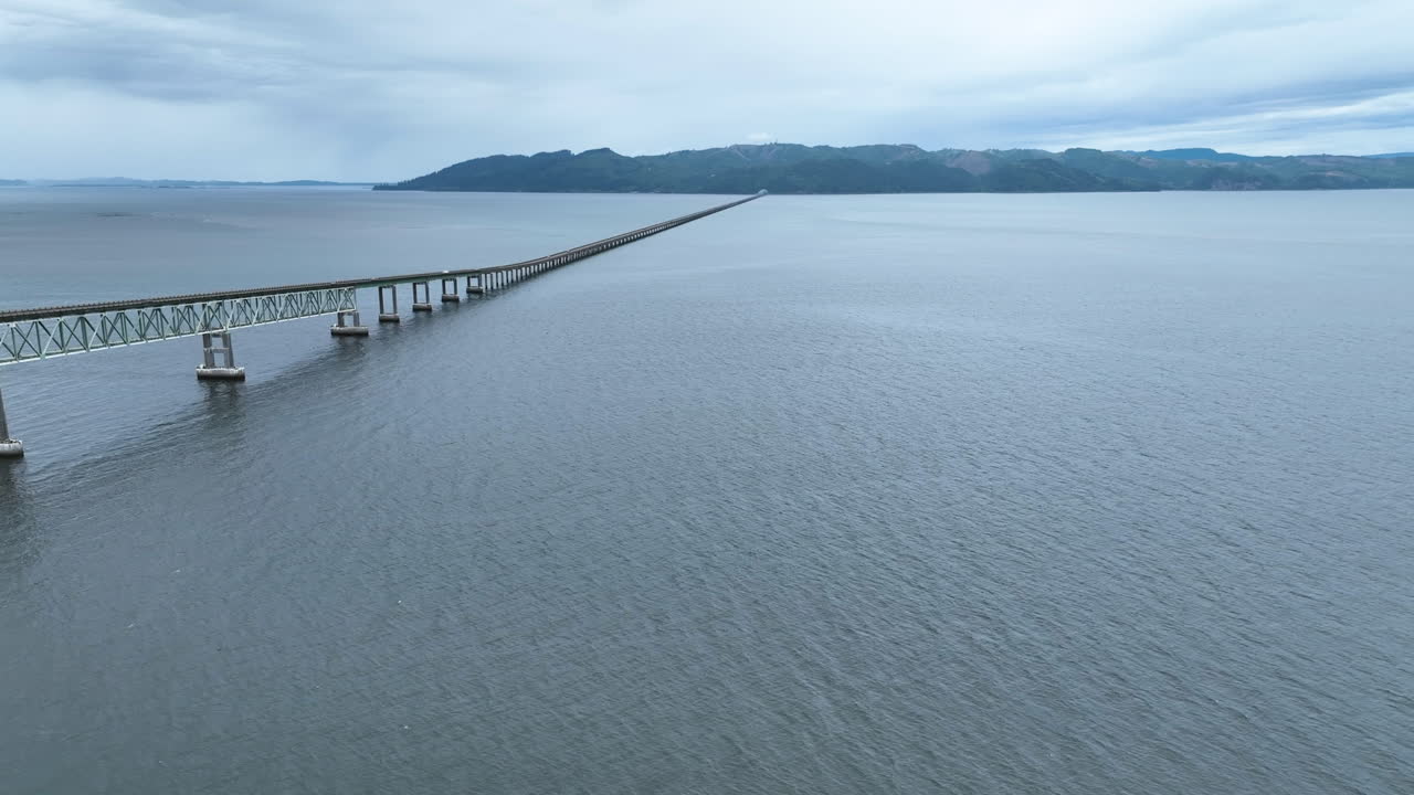 Aerial view following the Astoria-Megler Bridge, overcast day in Oregon, USA