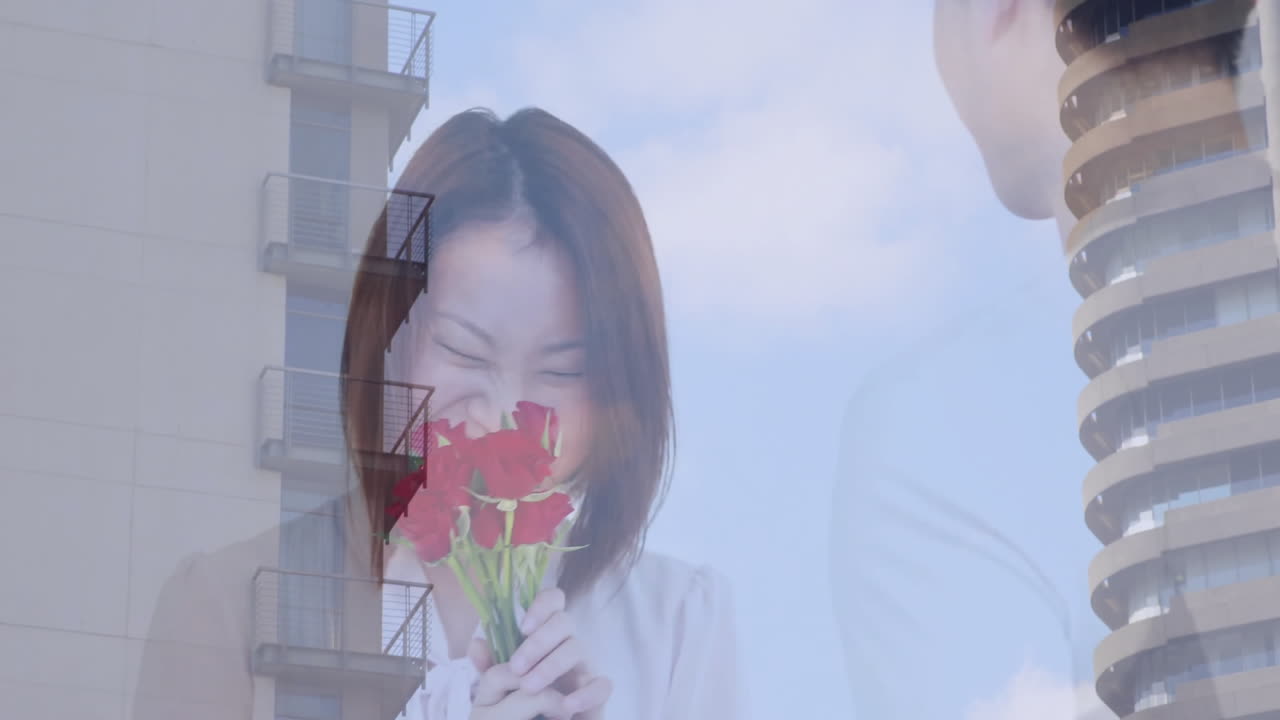 Smelling red roses, woman with building and sky animation in background
