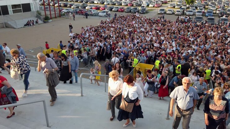 People crowd crowded standing in line queue to enter Armeec hall for event performance in Sofia, slow motion