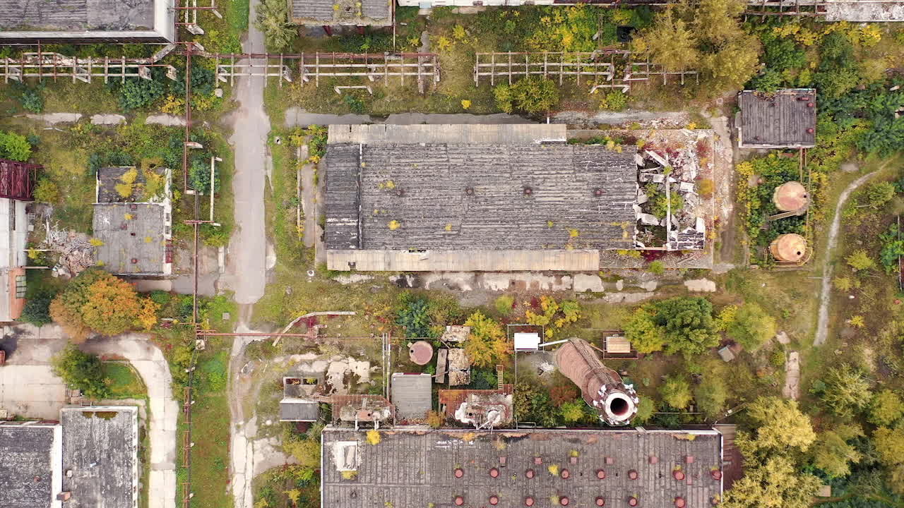 Abandoned destroyed factory territory. Old ruined empty industrial architecture.