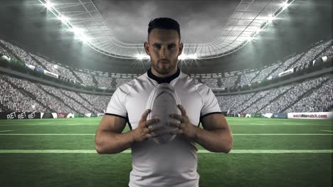 serious rugby player holding rugby ball