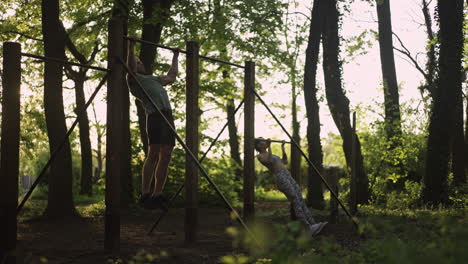 people doing pull-ups in a park