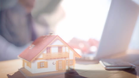 digital animation of house model and executive using laptop 4k