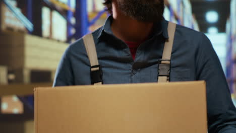 Packaging-engineer-carrying-cargo-boxes-in-depot